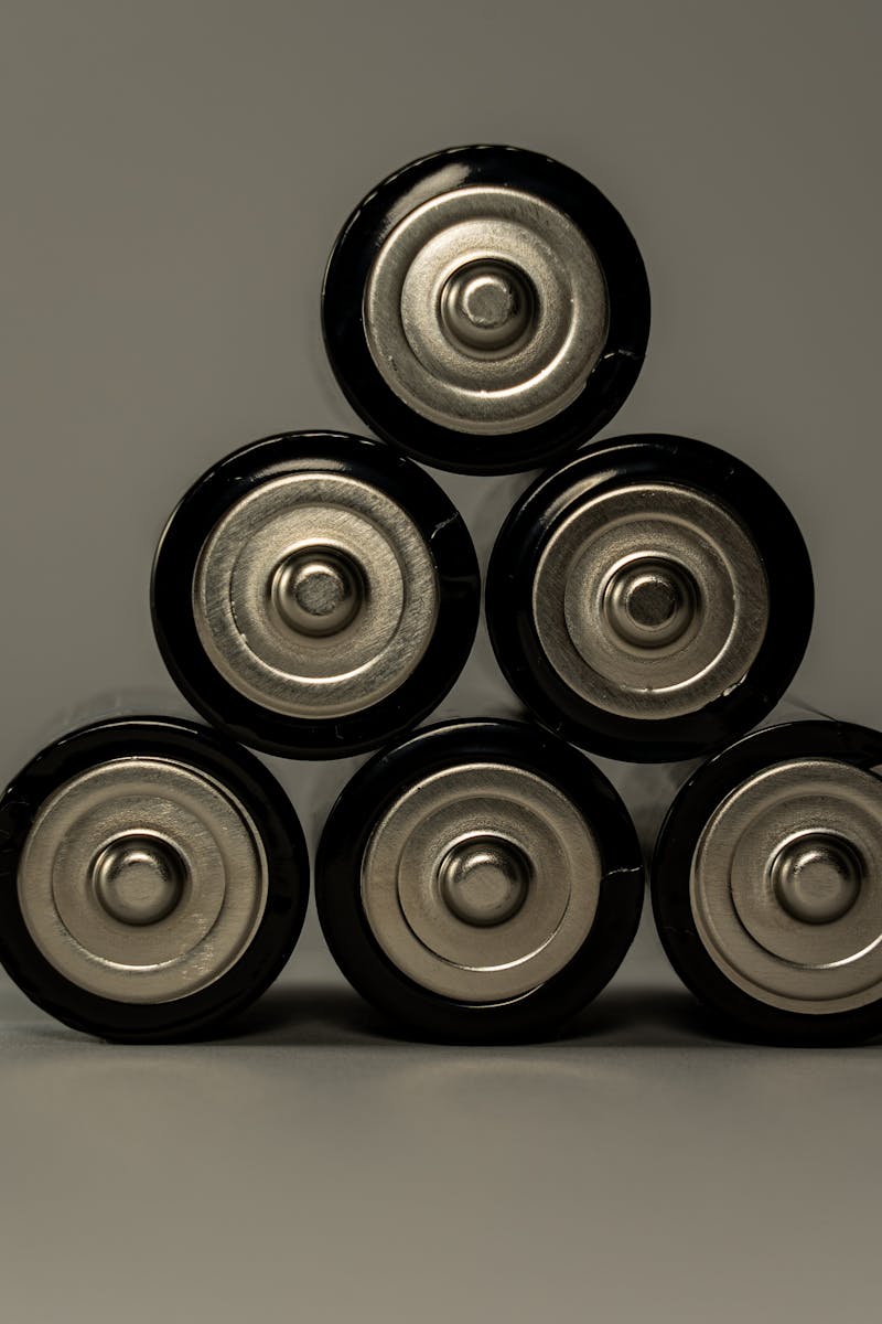 Metallic AA batteries stacked in a pyramid shape, symbolizing power and energy storage.